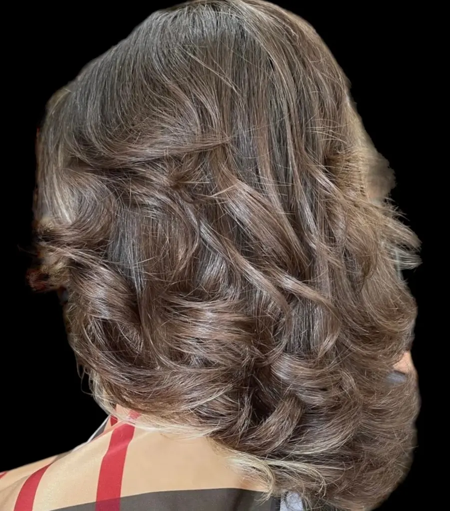 Balayage in Boca Raton: Natural Sun-Kissed Color 4 Dimensional brunette color with soft curls at Hairmess Salon