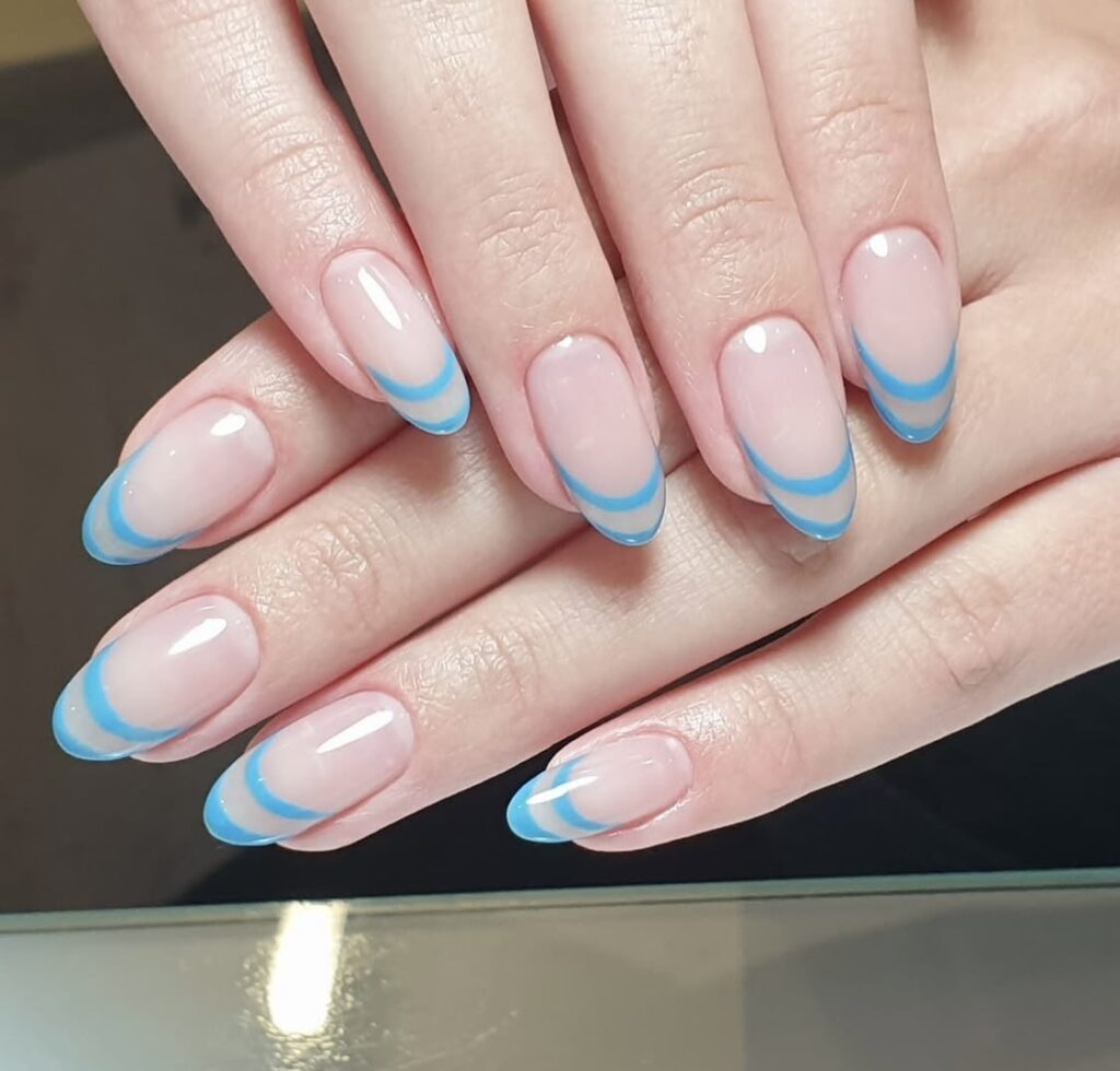 Blue French tips nail design on a client of Hairmess Salon in Boca Raton