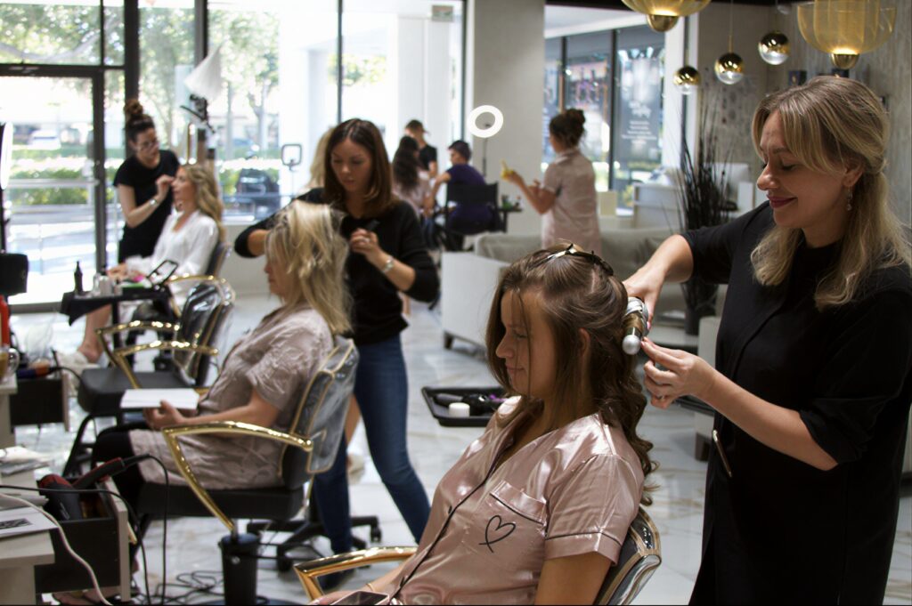 Stylists working with clients on salon services Boca Raton guests book