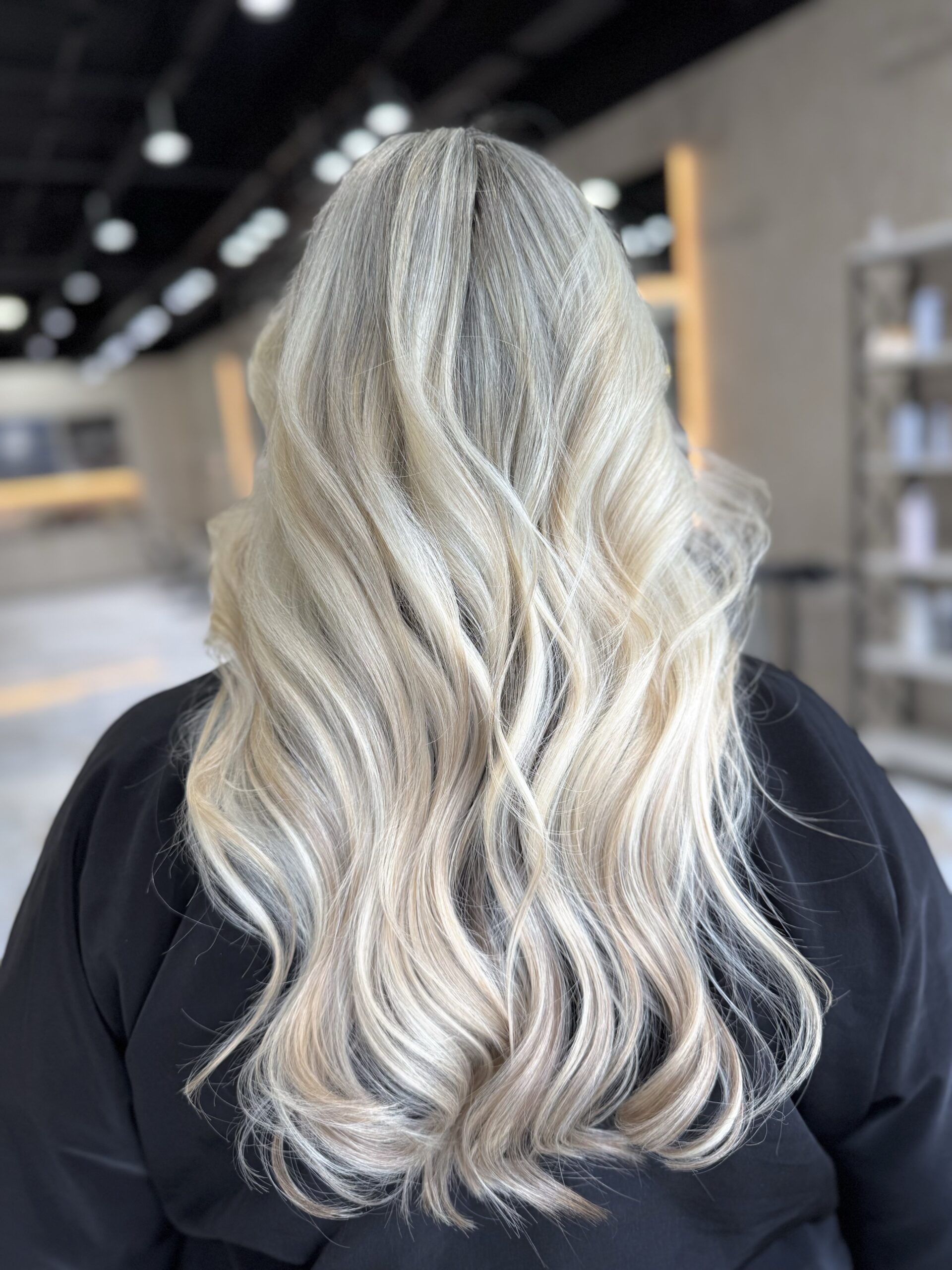 Icy blonde waves after color work at Hairmess Salon